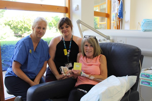 Macmillan Renton Unit patient receiving teddy bear gift pack from hospital staff Macmillan Renton Unit patient receiving teddy bear gift pack from hospital staff